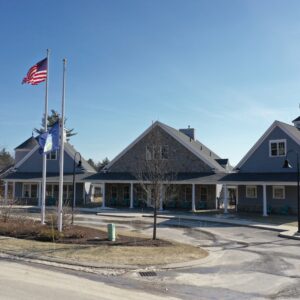 The American flag flying in front of three new cottages.
