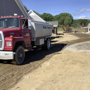Dust control truck at work at the job site.