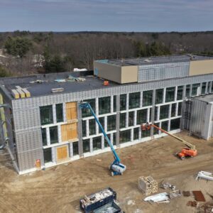 Side view of judicial center with metallic siding and a plethora of windows.