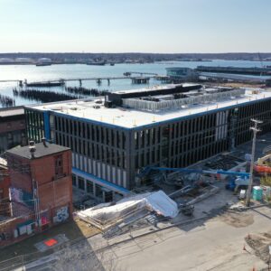 New modern building with the ocean in the background.