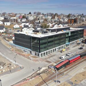 New modern building with Munjoy Hill in the background.