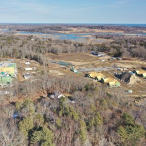 Aerial view of new housing with river and ocean in the background.