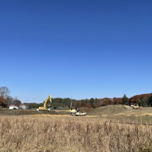 New excavation site with heavy equipment in motion.