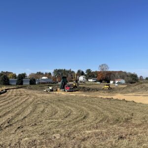 Distant photo of the site with heavy equipment in motion.
