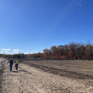 Two employees are walking the site.