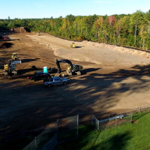 Aerial view of the job site with heavy equipment in action.