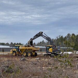 An excavator loading a dump truck.