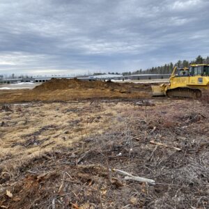 Heavy machinery leveling the job site.