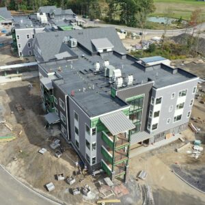 An aerial view of the top of a large building being constructed at the Piper Shores community worksite.