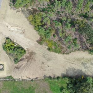 Aerial view of a dirt driveway leading to the work site of Summit Church