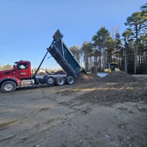 RJ Grondin dump truck unloading fill at the Mussy Road Apartments work site